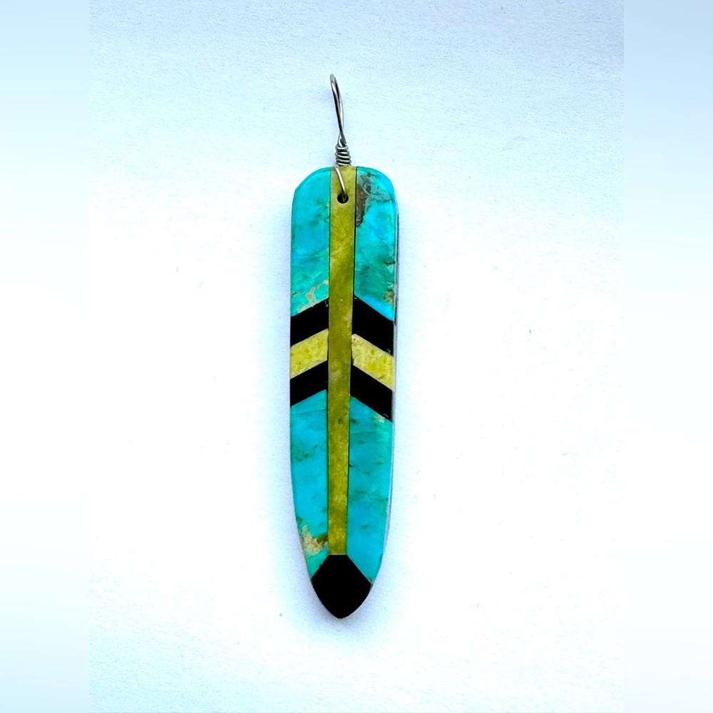 Turquoise, jet, and jasper inlaid feather pendant.